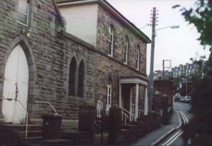 A granite chapel on a steep hill out of town