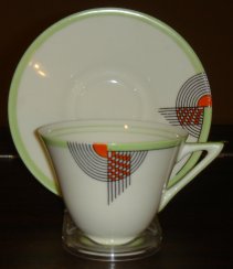 green and orange cup and saucer